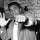 Cassius Clay holds up five fingers in a prediction of how many rounds it will take him to knock out British boxer Henry Cooper on May 27, 1963.